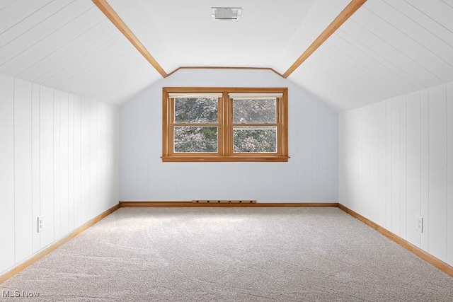 bonus room featuring baseboards, visible vents, carpet floors, and lofted ceiling