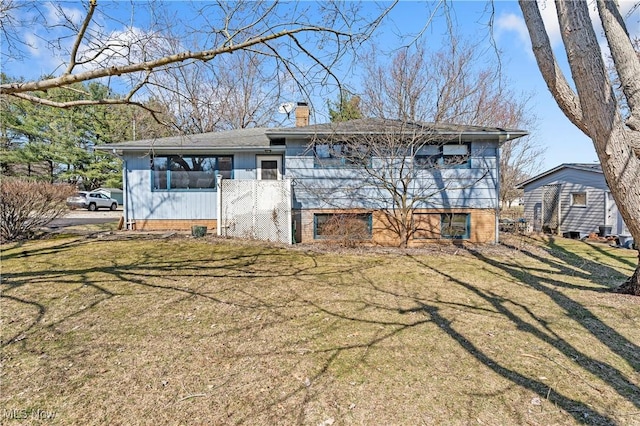 view of front of house featuring a front lawn and a chimney