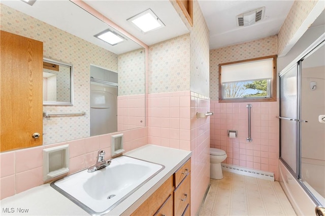 full bath with visible vents, wainscoting, wallpapered walls, and a baseboard radiator