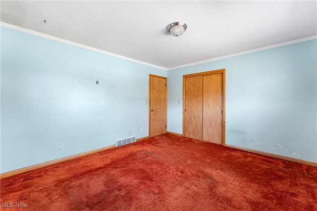 empty room with baseboards, carpet, visible vents, and ornamental molding