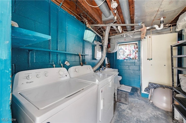 laundry area with a sink, washing machine and dryer, and laundry area