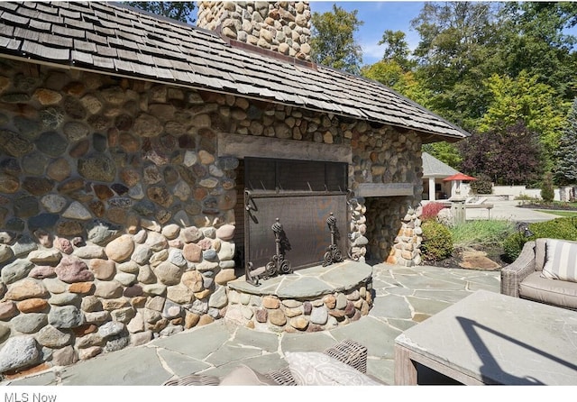 exterior space with an outdoor stone fireplace