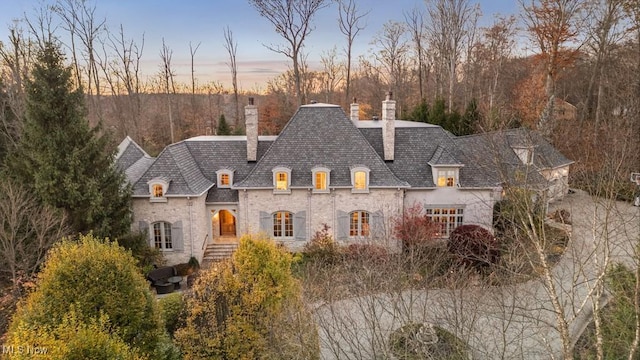 french country home featuring a chimney