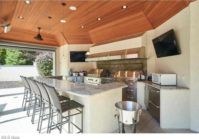 view of patio / terrace with outdoor wet bar, a grill, and exterior kitchen