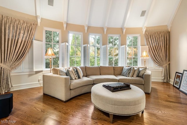 living room with beamed ceiling, wood finished floors, and baseboards