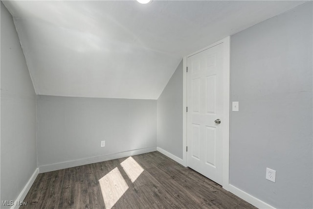 bonus room with baseboards, wood finished floors, and vaulted ceiling