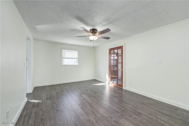 unfurnished room with dark wood-style floors, a textured ceiling, baseboards, and a ceiling fan