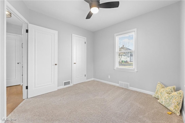 bedroom with visible vents, baseboards, a ceiling fan, and carpet flooring