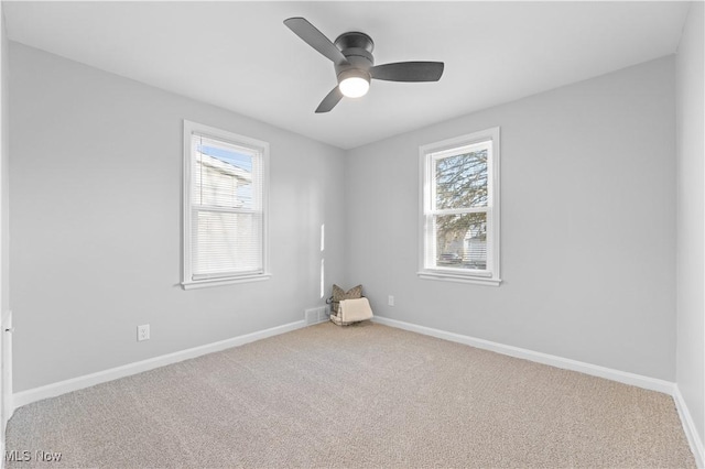 unfurnished room featuring carpet flooring, a healthy amount of sunlight, baseboards, and ceiling fan