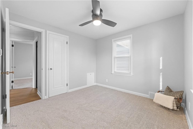 unfurnished bedroom with carpet flooring, baseboards, and ceiling fan