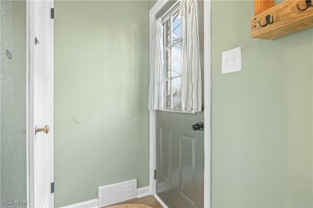 doorway with visible vents and baseboards