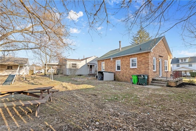 back of house featuring brick siding