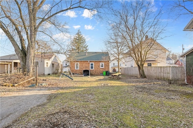 view of yard with a residential view, a playground, and fence