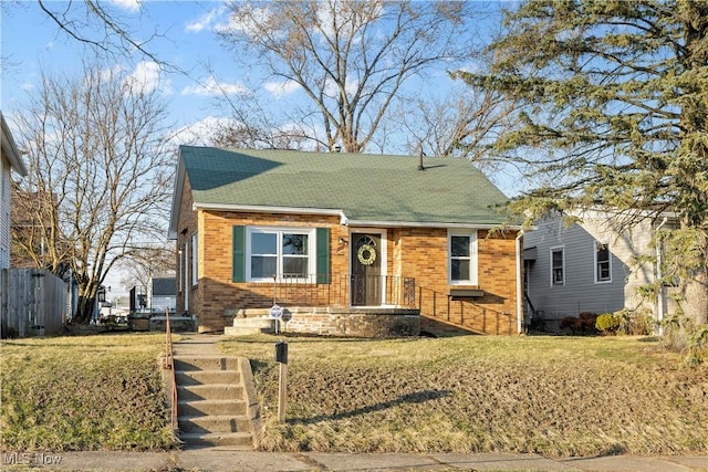 view of front facade featuring brick siding and a front lawn