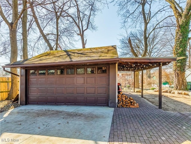 detached garage featuring fence