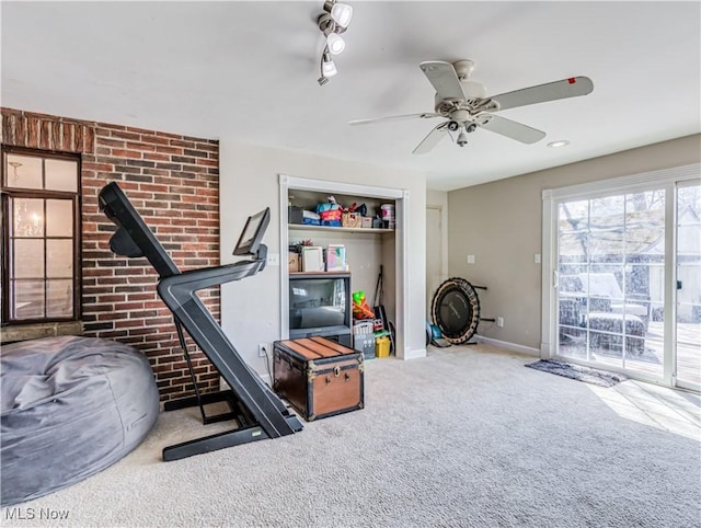 workout room featuring baseboards, carpet floors, and ceiling fan