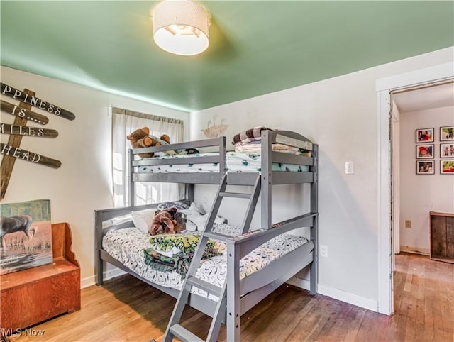 bedroom with baseboards and wood finished floors