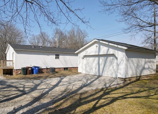 exterior space with an outbuilding and a detached garage