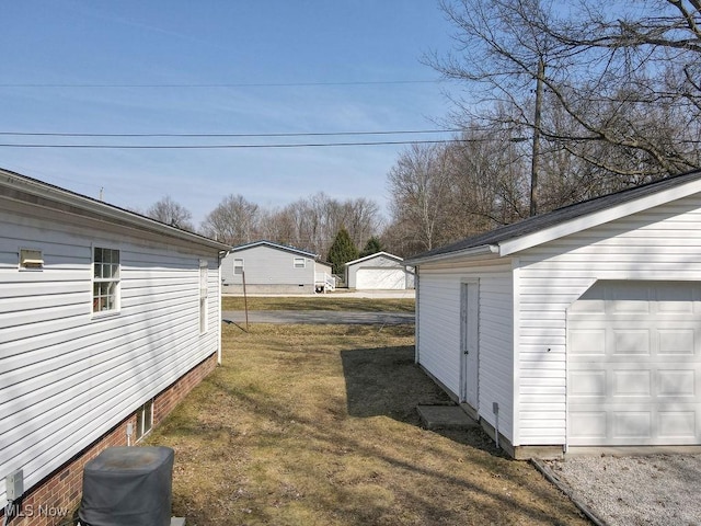 view of yard with an outbuilding and a garage