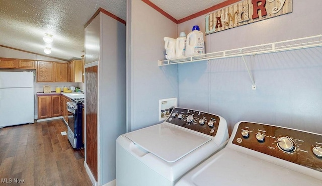 laundry area featuring separate washer and dryer, a textured ceiling, dark wood finished floors, and laundry area