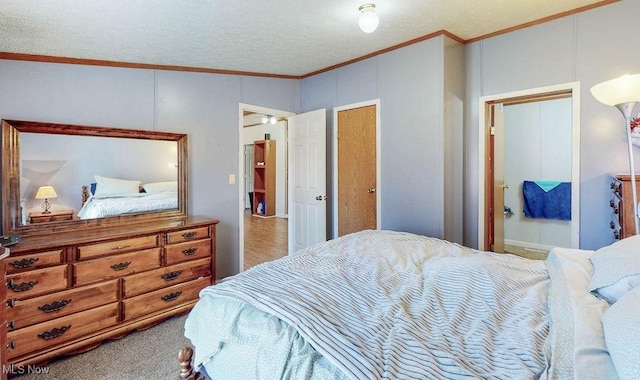 carpeted bedroom featuring a textured ceiling and ornamental molding