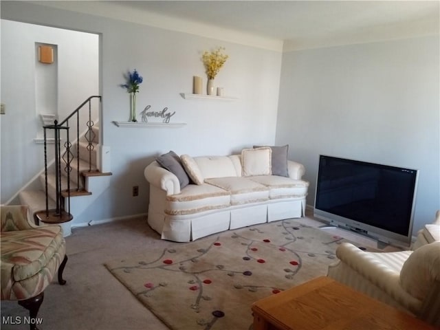 living area featuring stairway, carpet floors, and baseboards