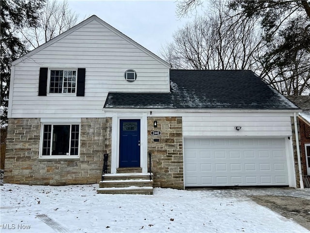 view of front of house featuring stone siding, roof with shingles, and an attached garage