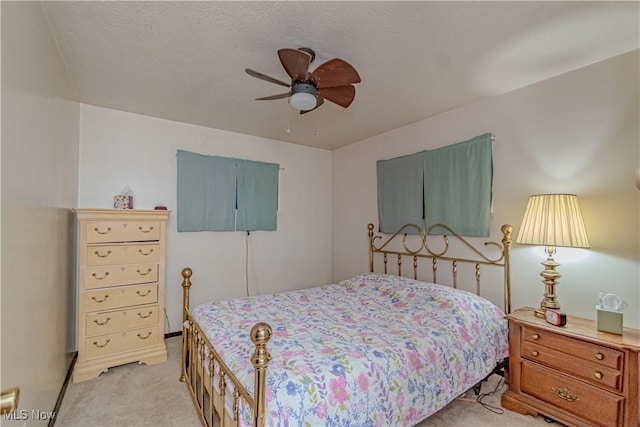 bedroom featuring light carpet and ceiling fan