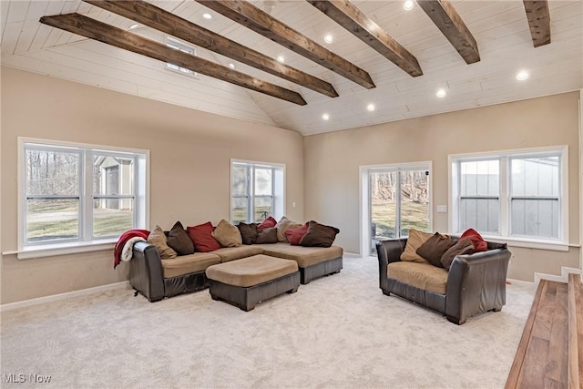 living room featuring a wealth of natural light, beamed ceiling, baseboards, and carpet floors