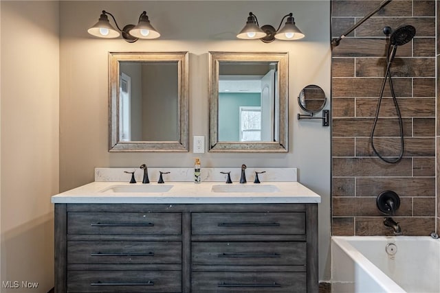 full bathroom with double vanity, shower / tub combination, and a sink