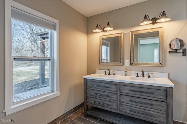 bathroom with a wealth of natural light, double vanity, and a sink