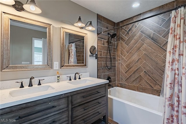 bathroom featuring double vanity, shower / bath combo with shower curtain, and a sink