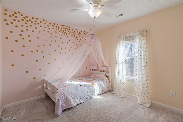 unfurnished bedroom featuring carpet flooring, baseboards, visible vents, and a textured ceiling