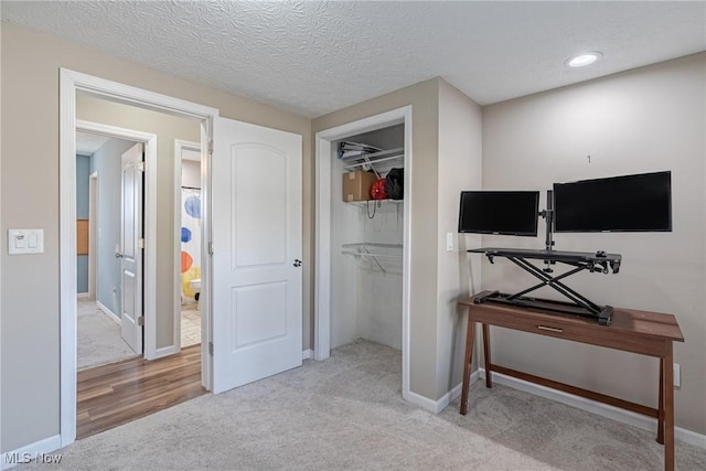 bedroom with a textured ceiling, recessed lighting, a closet, carpet floors, and baseboards