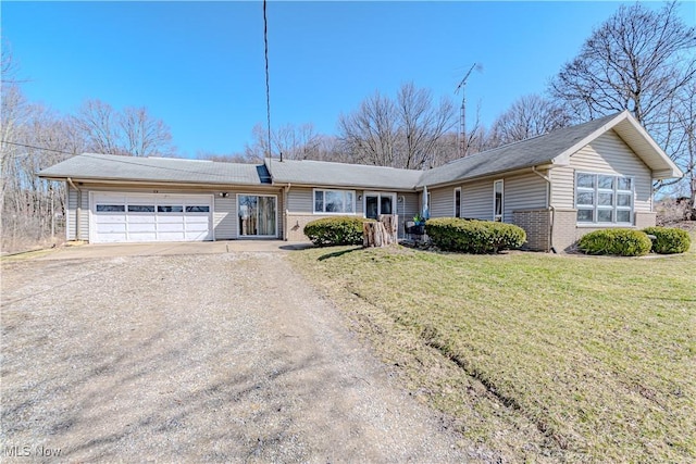 ranch-style house with a garage, a front lawn, brick siding, and driveway