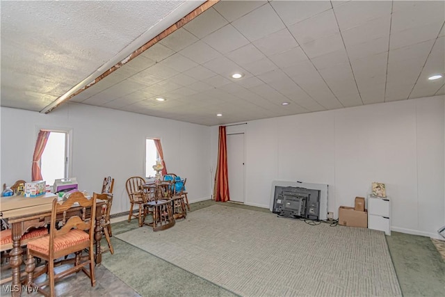 interior space featuring a wood stove, recessed lighting, and carpet floors