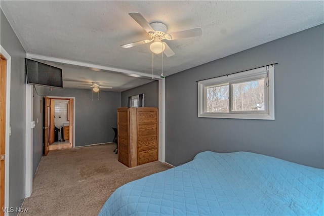 bedroom with a textured ceiling, carpet, and a ceiling fan