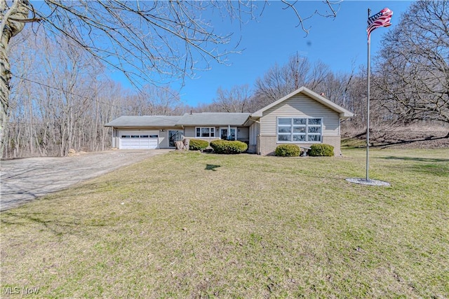 ranch-style house featuring brick siding, a garage, a front lawn, and driveway