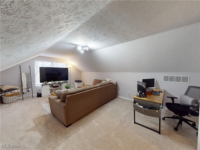 living area with visible vents, baseboards, lofted ceiling, a textured ceiling, and light colored carpet