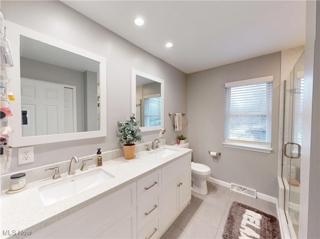 bathroom with tile patterned floors, visible vents, a stall shower, and a sink