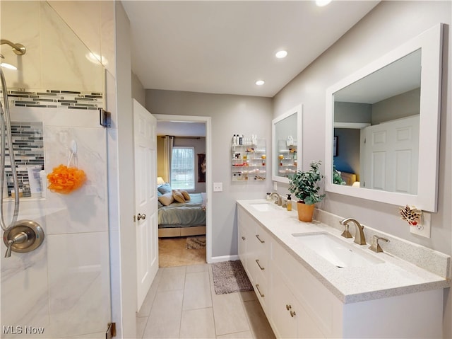 bathroom with a shower stall, double vanity, ensuite bathroom, and a sink