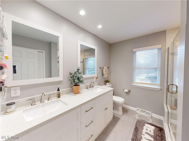 full bathroom with tile patterned floors, a stall shower, visible vents, and a sink