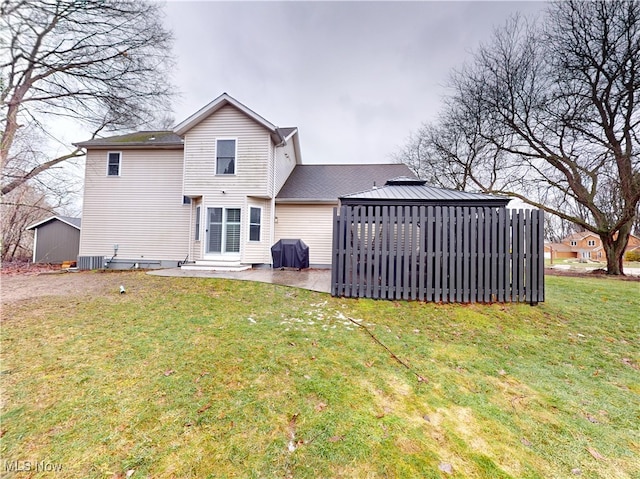 back of property with cooling unit, a patio, a lawn, and entry steps