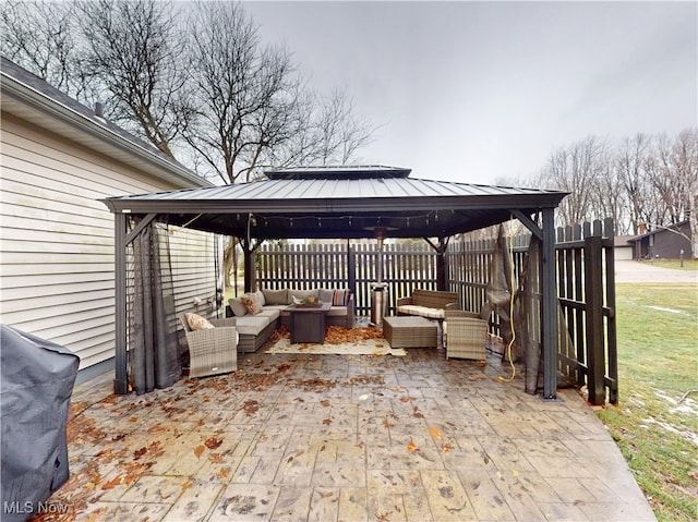 view of patio with a gazebo, fence, an outdoor living space, and a grill