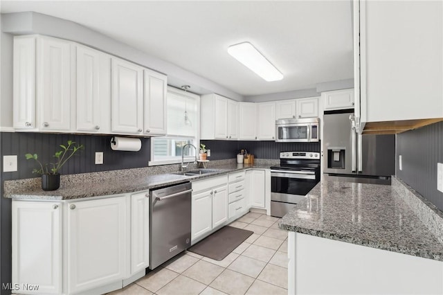 kitchen with white cabinetry, stainless steel appliances, and a sink