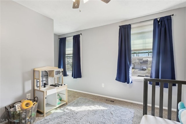 carpeted bedroom featuring visible vents and baseboards