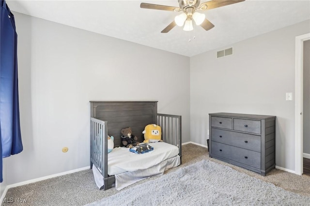 carpeted bedroom featuring visible vents, a ceiling fan, and baseboards