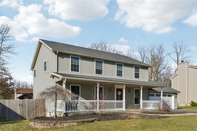 view of front facade featuring fence, covered porch, and driveway