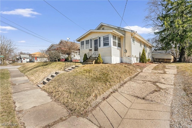 bungalow-style home featuring entry steps