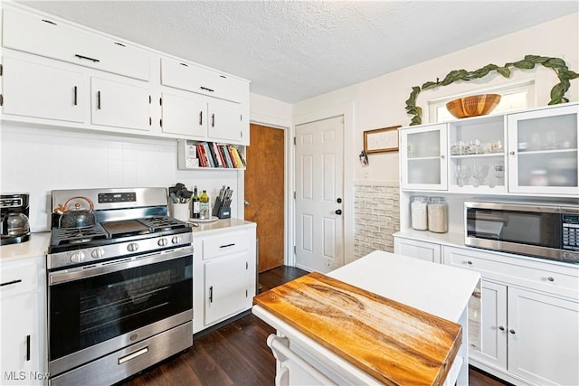 kitchen featuring light countertops, white cabinets, appliances with stainless steel finishes, and a textured ceiling